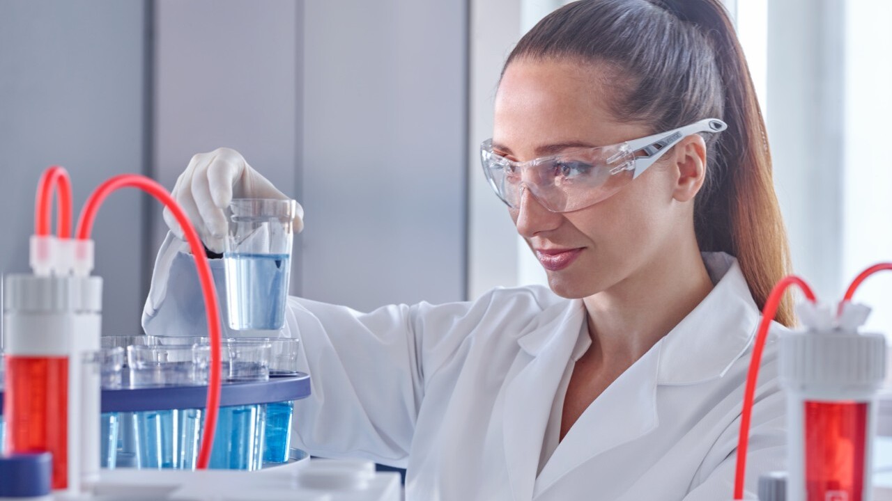 Lab scientist using automated titrator in a lab