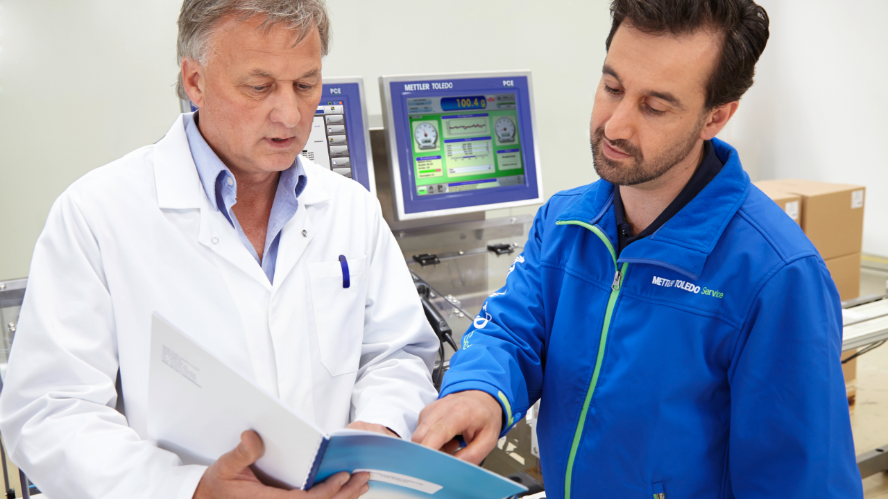 customer and service technician looking at a document