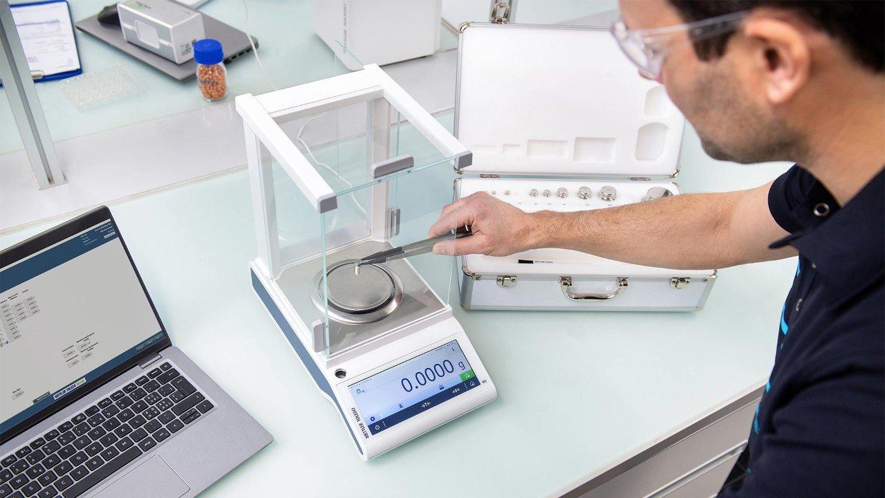 researcher using a balance