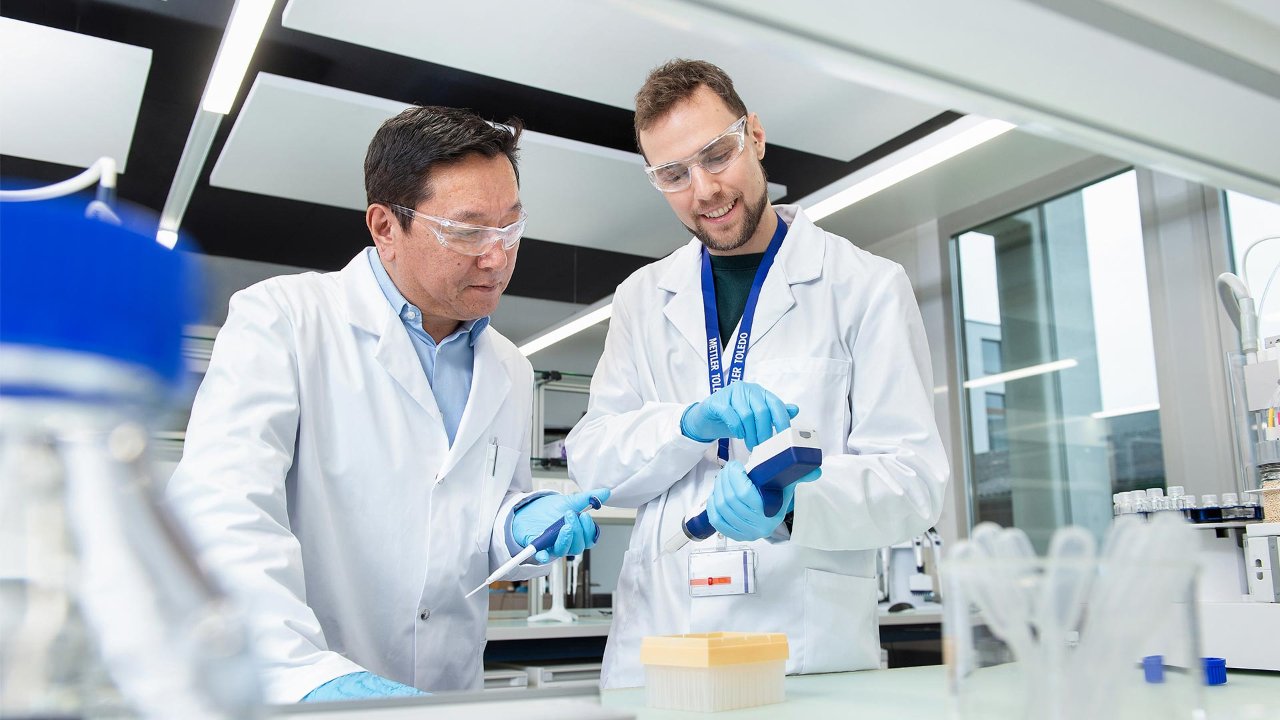 lab scientists holding a pipette