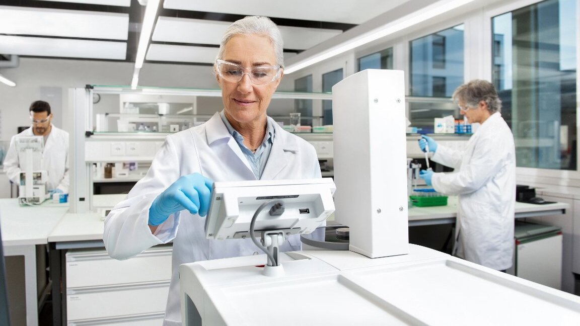 Scientist holding test tubes in modern laboratory