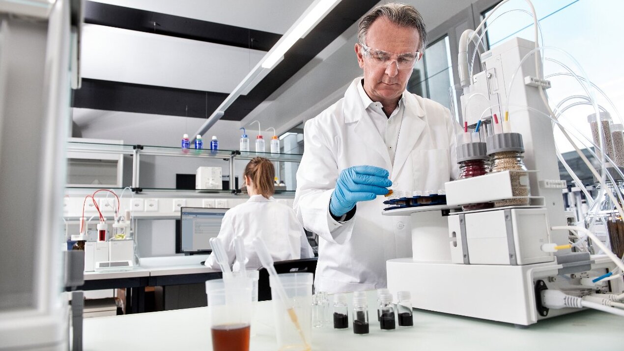 Scientist handling test tubes in lab setting