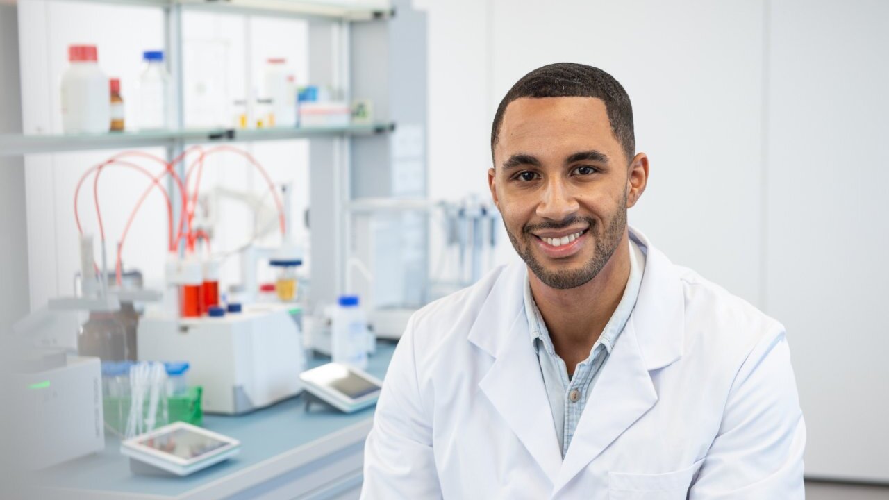 Scientist smiling sitting in a lab