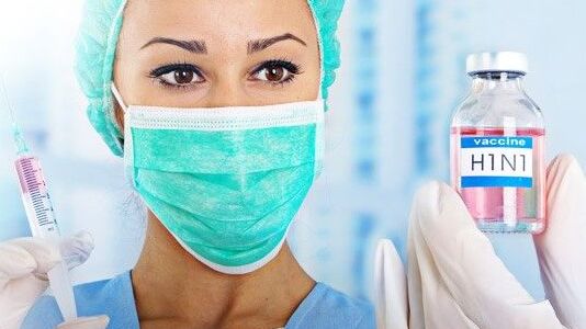 Doctor holding syringe and medicine