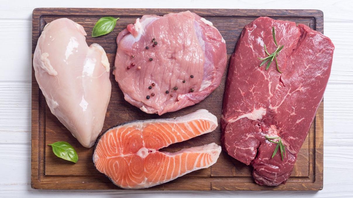 Raw meats and poultry on a table